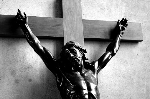 A statue of the holy crucifix located on the historic Charles Bridge in Prague, Czech Republic.