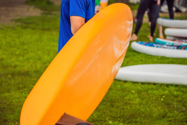 istock SUP boards lying on the grass by the river, lake or sea 1130245712