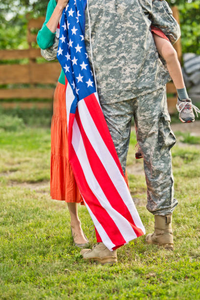 American happy family Happy family reunited, father in military uniform returns home . Us happy family portrait. focus on man proud army mom stock pictures, royalty-free photos & images
