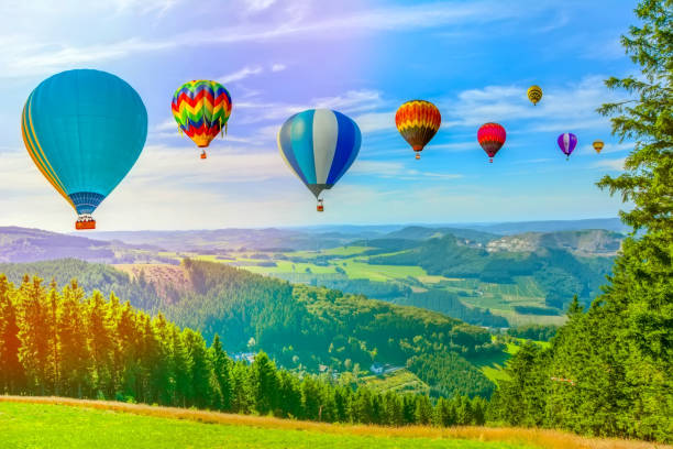 istock Hot air balloon flying over amazing mountains 1130247927