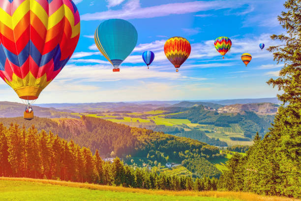 istock Hot air balloon flying over amazing mountains 1130248305