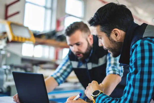 Photo of Two industrial engineers with laptop