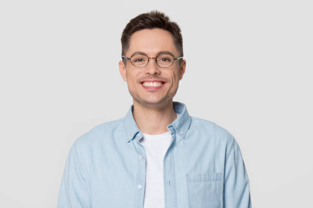 istock Smiling man wearing glasses looking at camera isolated on background 1130250025