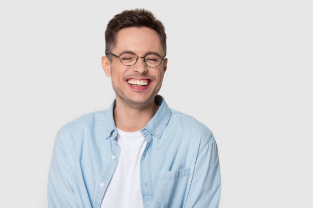 istock Happy man wearing glasses laughing at joke isolated on background 1130250031