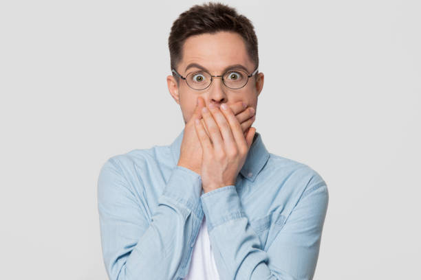 istock Shocked scared man with surprised face covering mouth with hands 1130250041