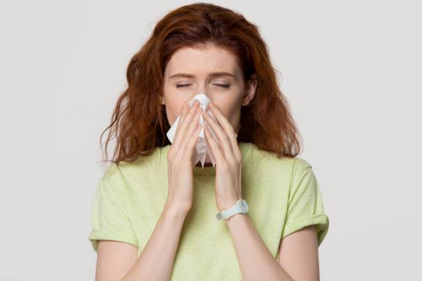 istock Allergic sick red-haired woman blowing nose in tissue got flu 1130250131