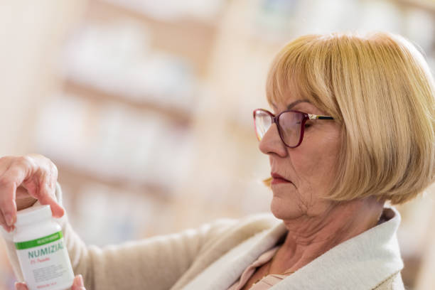 istock Senior Woman Shopping At Pharmacy 1130251189