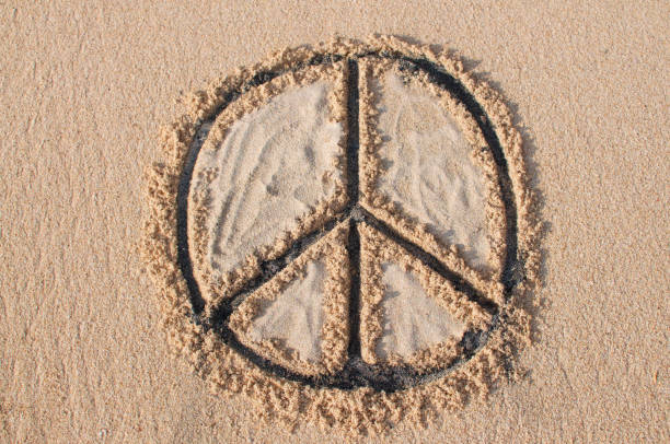 Peace symbol drawn at the beach stock photo