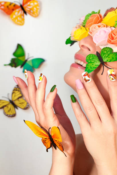 istock Summer nail design with stickers from butterflies 1130253094