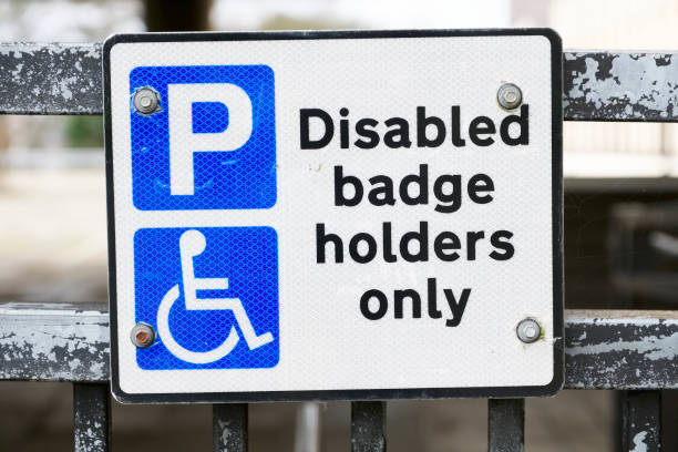 istock Disabled Badge Holders Only at Car Park Sign Post 1130253717