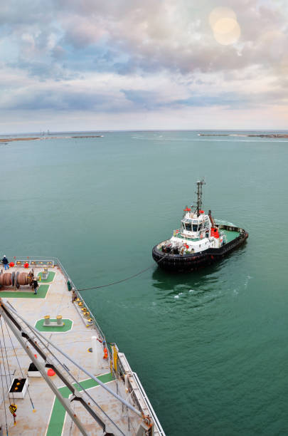istock Tugs in action in port 1130254177