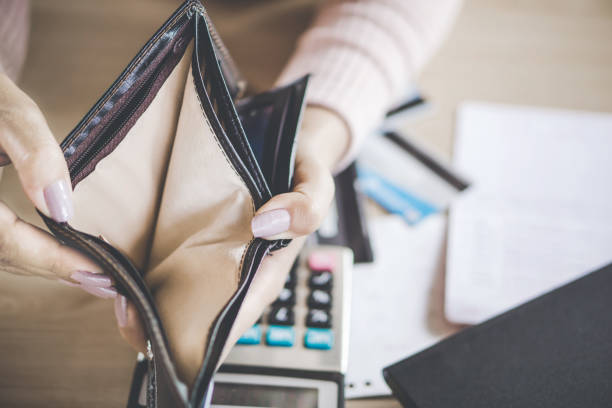 istock poor Asian woman hand open empty purse looking for money for debt 1130254859