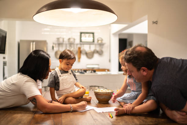 istock Family with twin sibling (Down Syndrome Boy and Girl) drawing at table 1130254925