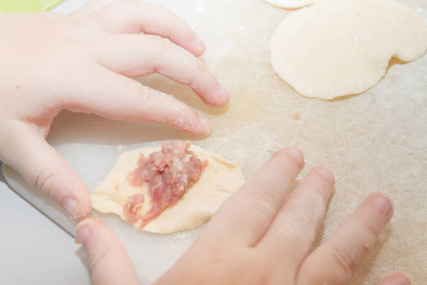 istock Small boy sculpts a homemade ravioli at home 1130255021