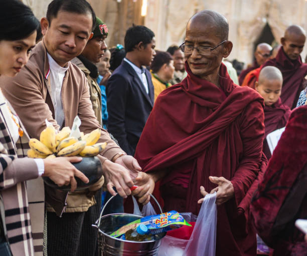 Bagan/Myanmar - January 19,2019:  monk receiving alms at the annual festival at the Ananda Pagoda