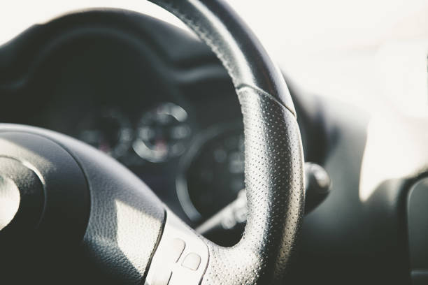 istock Steering wheel of a modern car, blurry dashboard 1130255376