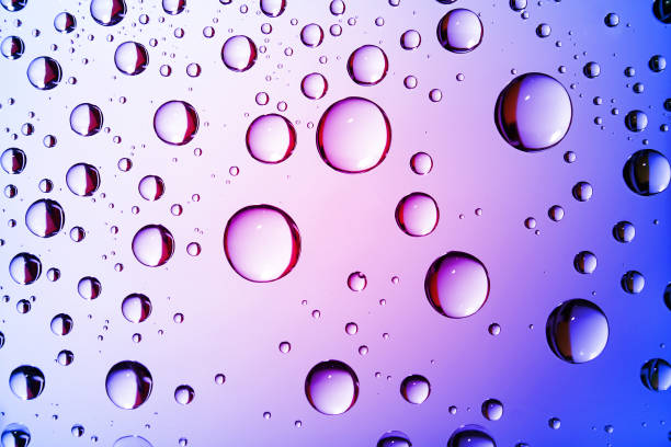 istock Dripped water on glass. Pink blue abstract background 1130256479