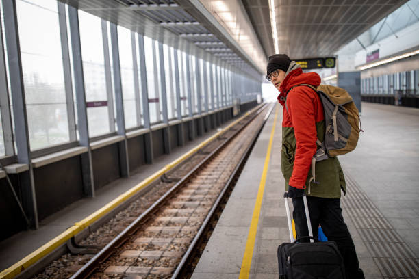 istock Tourist with a backpack waiting for a train at the train station 1130257481