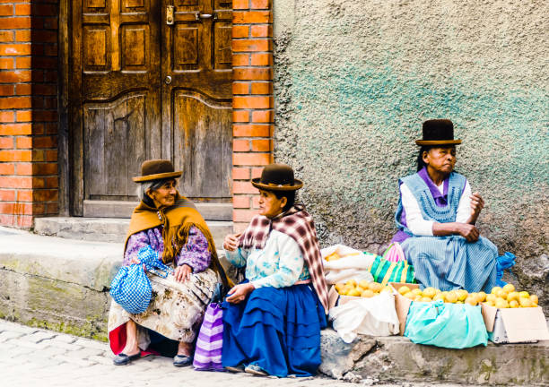 Coroico, Bolivia - Group of indigenous woman selling local products on market Coroico, Bolivia on 3rd May 2017: View on group of indigenous woman selling local products on market bolivian andes photos stock pictures, royalty-free photos & images