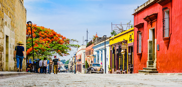Oaxaca, Mexico on 24th April 2016: View on street with Colorful colonial buildings in th eold town with a group of people