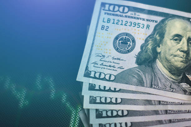 istock Dollar banknotes against stock market or forex trading graph and a candlestick chart, toned photo. Economy trends concept 1130260204
