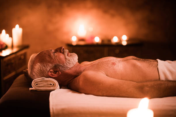 istock Senior man relaxing on a massage bed at the spa. 1130261618