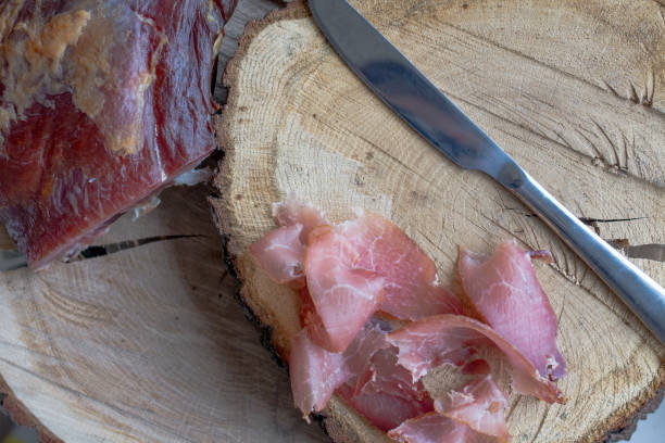 istock prosciuto slices  on wooden chopping board 1130264448