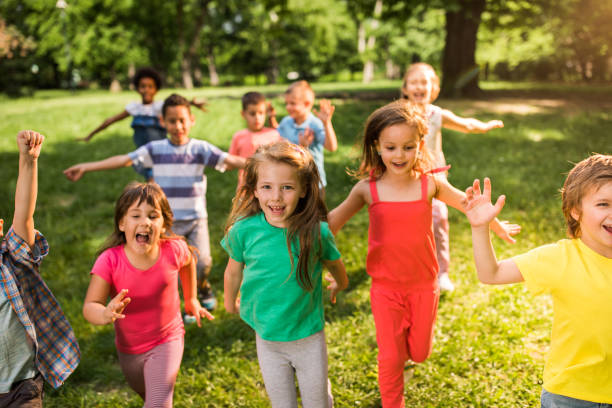 istock Carefree children having fun while running in spring day at the park. 1130264669