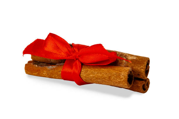 istock Cinnamon sticks on a white background with party ribbon 1130266345