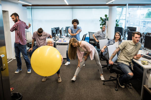 istock Group of programmers exercising on a break in the office. 1130267410