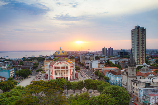 August 27, 2013 - Manaus, Brazil: Sunset over the city of Manaus, showing the front view the Opera house of Manaus, the buildings, streets and the Rio Negro river in the background.