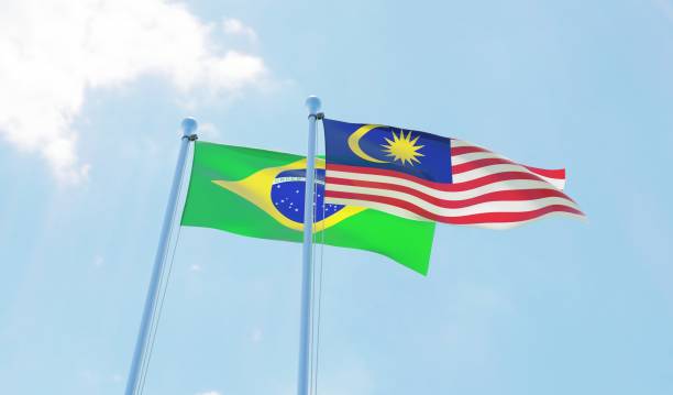 istock Malaysia and Brazil, two flags waving against blue sky 1130268387