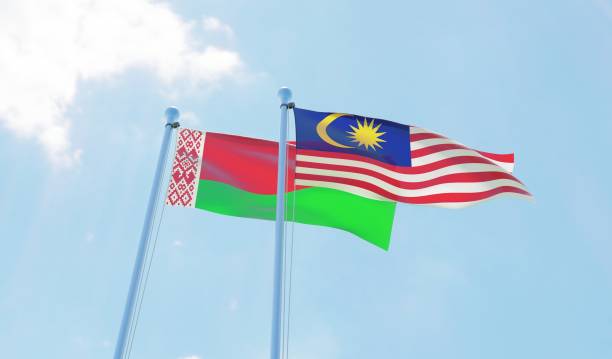 istock Malaysia and Belarus, two flags waving against blue sky 1130268402