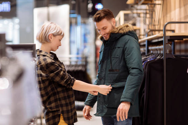 istock Cute man trying on new jacket 1130271279