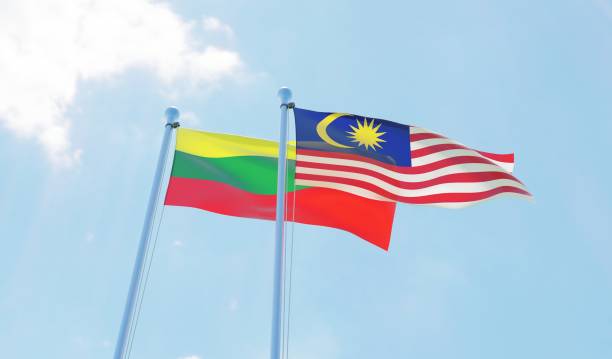 istock Malaysia and Lithuania, two flags waving against blue sky 1130272288