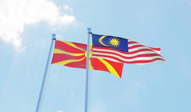 istock Malaysia and Macedonia, two flags waving against blue sky 1130272317