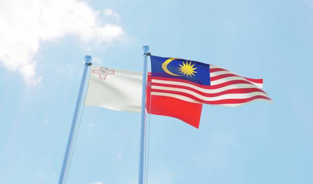 istock Malaysia and Malta, two flags waving against blue sky 1130272327
