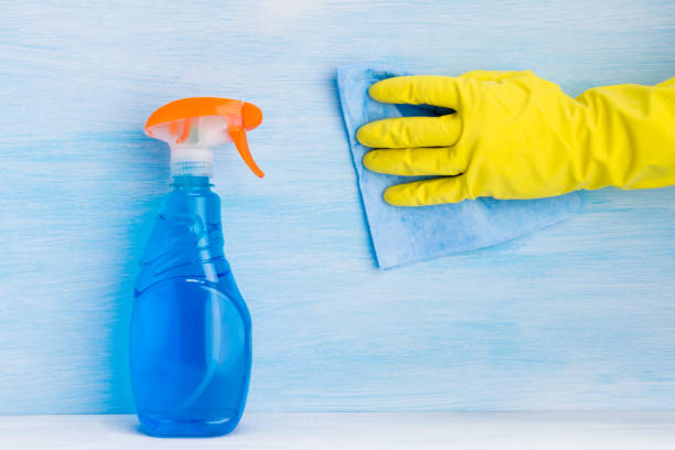 istock glass cleaner and rag in hand on a light background 1130272472