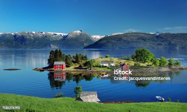 Hardangerfjord In South Western Norway In The Summer A Red Norwegian House Situated On A Small Island In The Fjord In The Distance The Folgefonna Glacier Stock Photo - Download Image Now