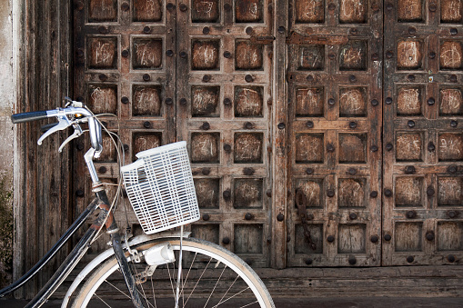 A bike in front of an African wood door in Stone Town, on the Zanzibar Island, Tanzania