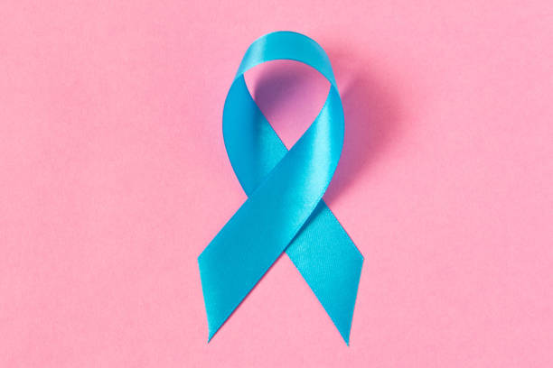 istock Blue ribbon.  Isolated on pink background with empty space for text. Close up. 1130278547