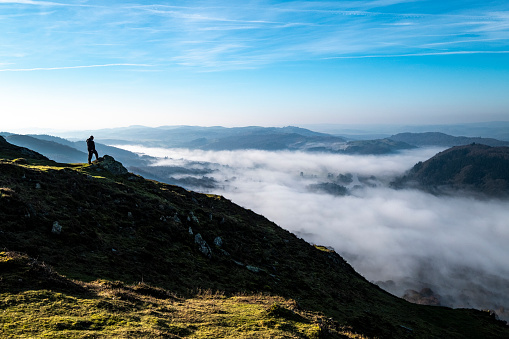 English Lake District scenic from Gummers How with one person looning down at inversion