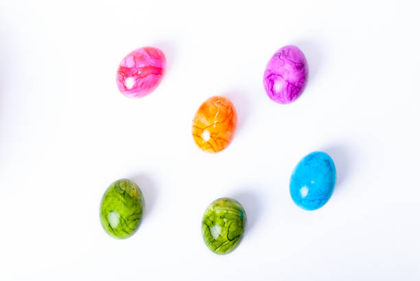 colorful painted easter eggs laying on white background - red easter blue frame imagens e fotografias de stock