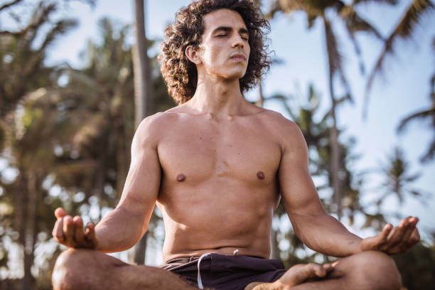 istock Handsome shirtless man meditating in nature 1130283046