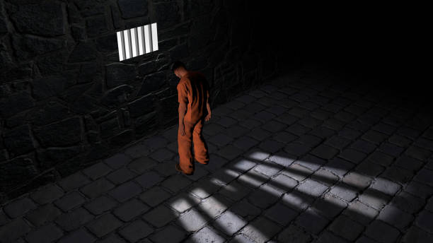 istock Prison cell, inside a prison cell. Shadows projected on the ground, cell window. Detained in front of a window 1130284593