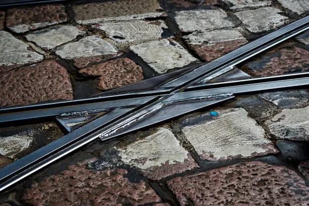 Photo of Tram lines on the background of the old stone