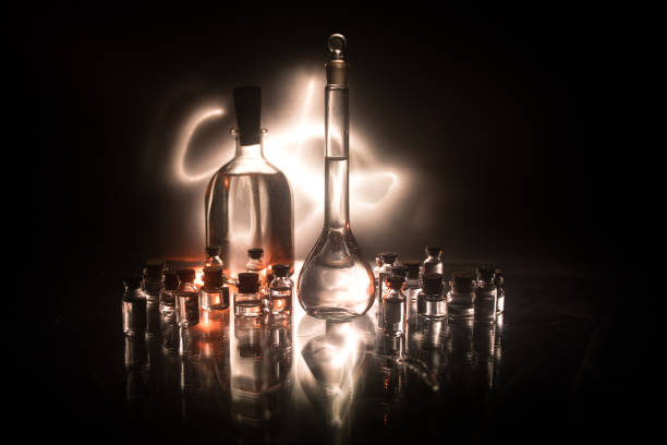 istock Pharmacy and chemistry theme. Test glass flask with solution in research laboratory. Science and medical background. Laboratory test tubes on dark toned background 1130286981