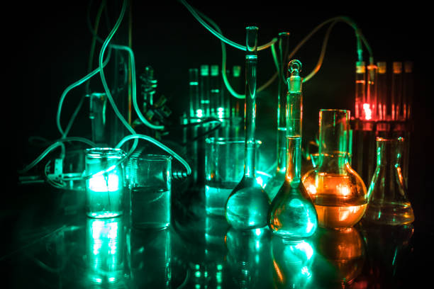 istock Pharmacy and chemistry theme. Test glass flask with solution in research laboratory. Science and medical background. Laboratory test tubes on dark toned background 1130286983
