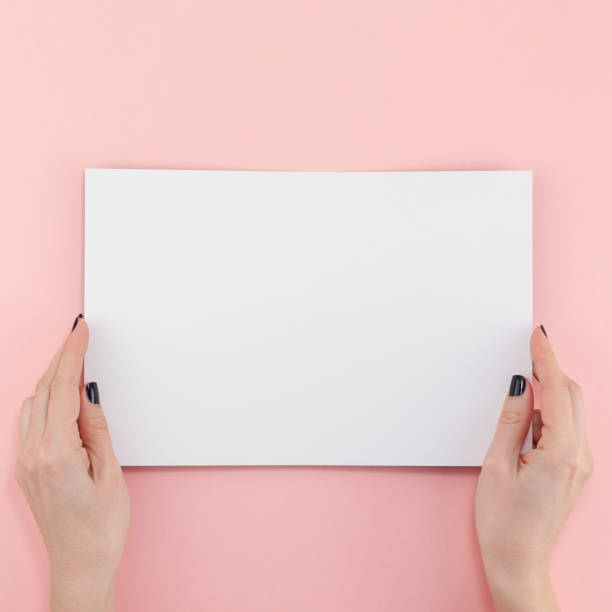 istock Woman hands with blank A4 paper sheet mockup 1130288139