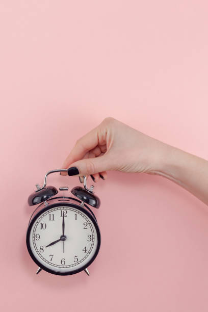 istock Female hand with alarm clock. Morning concept 1130288172